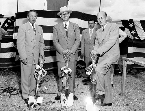 Left to right: J. L. Conlon, unidentified man, and John F. Gordon pose with shovels at the groundbreaking ceremony for the General Motors plant to be constructed in Arlington, Texas.